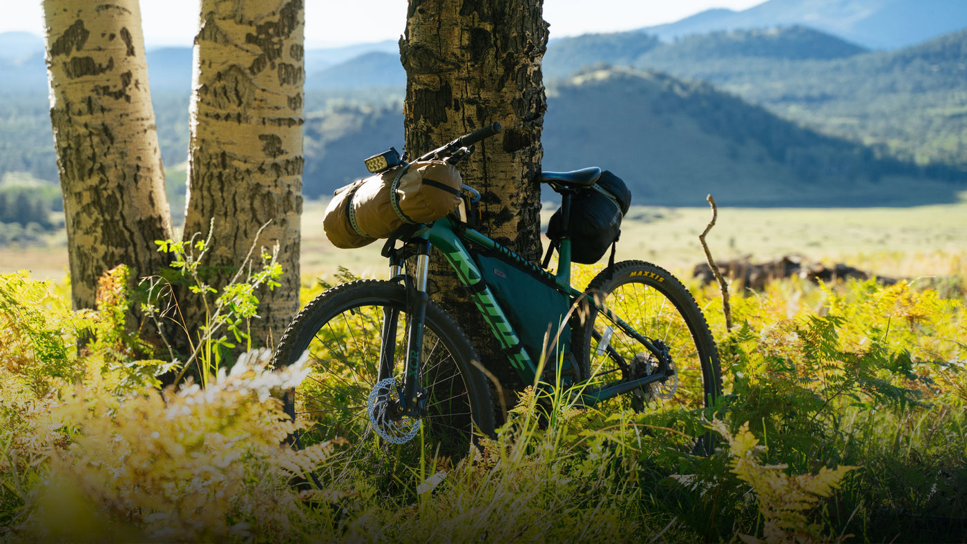 Bikepacker with a Routewerks bag and a Kona mountain bike on a trip