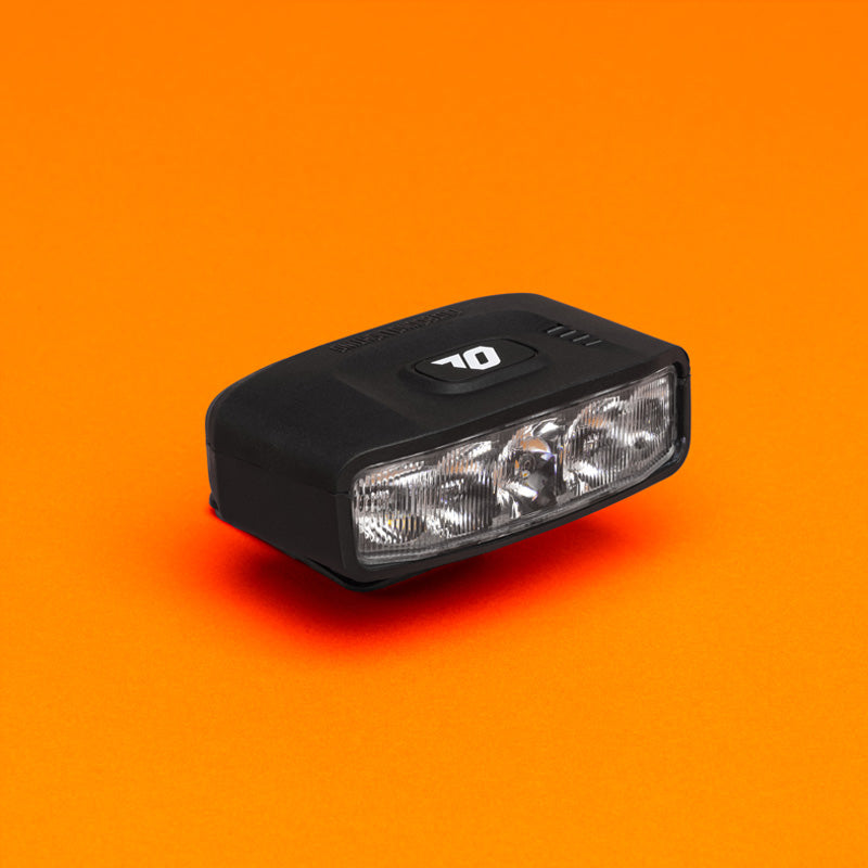 Portal helmet bike light product close-up on orange background