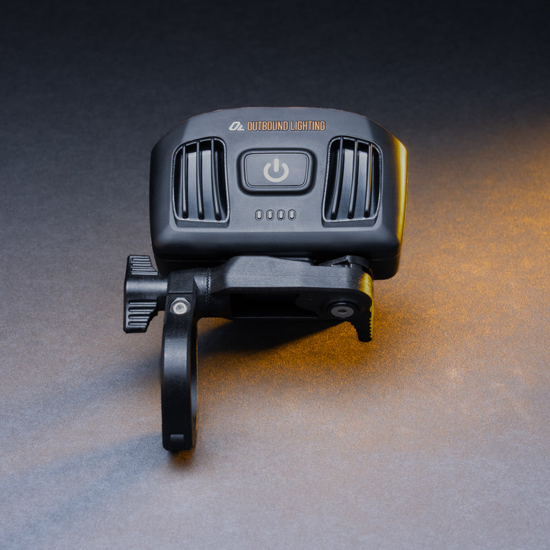 Detour bike headlight on its quick release handlebar mount, rear view showing the power button and battery indicator