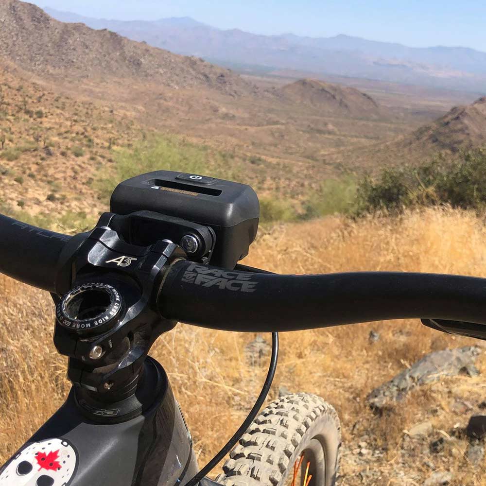 bike light on handlebar rear view in mountains