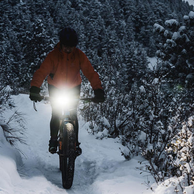 bike light on handlebar riding in snow 