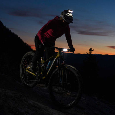 bright bike light and helmet light with night rider on trail