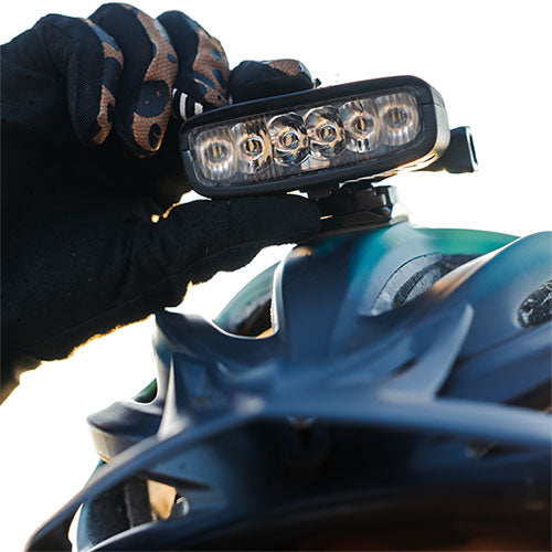 close up front view of bike helmet light with rider 